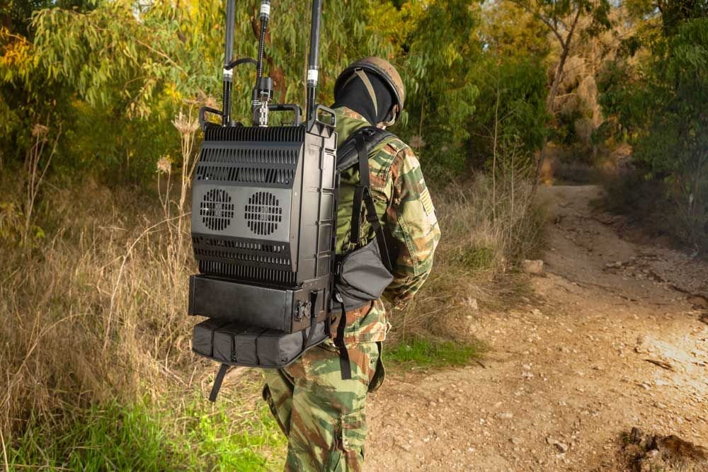 Soldier operating a man-portable communications system in the field